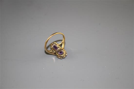 An early to mid 20th century 9ct, amethyst and seed pearl set double cluster dress ring,